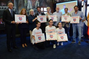 Carlos Alonso junto a un grupo de británicos con la imagen de la campaña promocional
